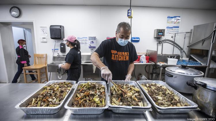 Albert Yee is the director
of community
needs and
coordinates
a program to
provide meals
for community
members out
of the kitchen.